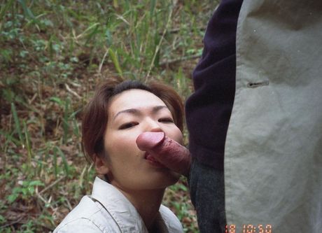 Asian amateur girl with a big booty gives a blowjob outdoors